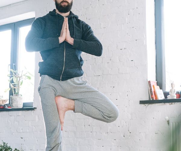 Focused man meditating after a workout session in a calm environment.